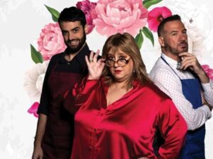 Una mujer de rojo con gafas y dos hombres vestidos con traje de dependiente