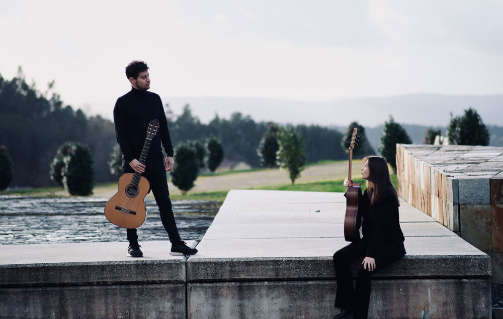 Un hombre y una mujer con guitarras del grupo Eresma Guitar Dúo en un paisaje de naturaleza