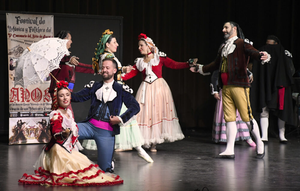 Varios bailarines sobre un escenario con trajes regionales castellanos