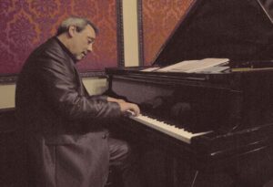 Un hombre tocando un piano en un salón