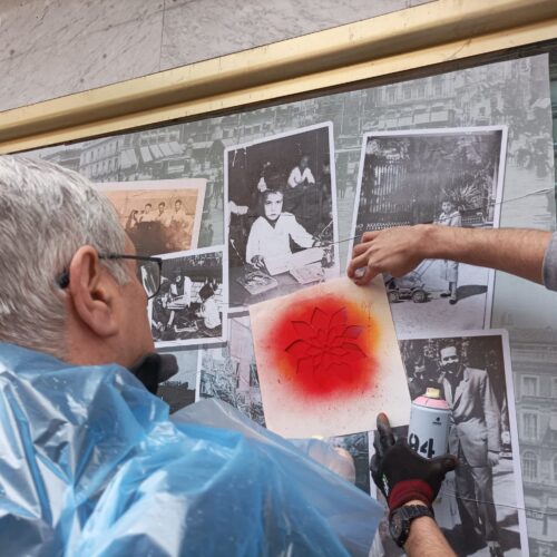 un hombre mayor de espaldas haciendo un graffiti