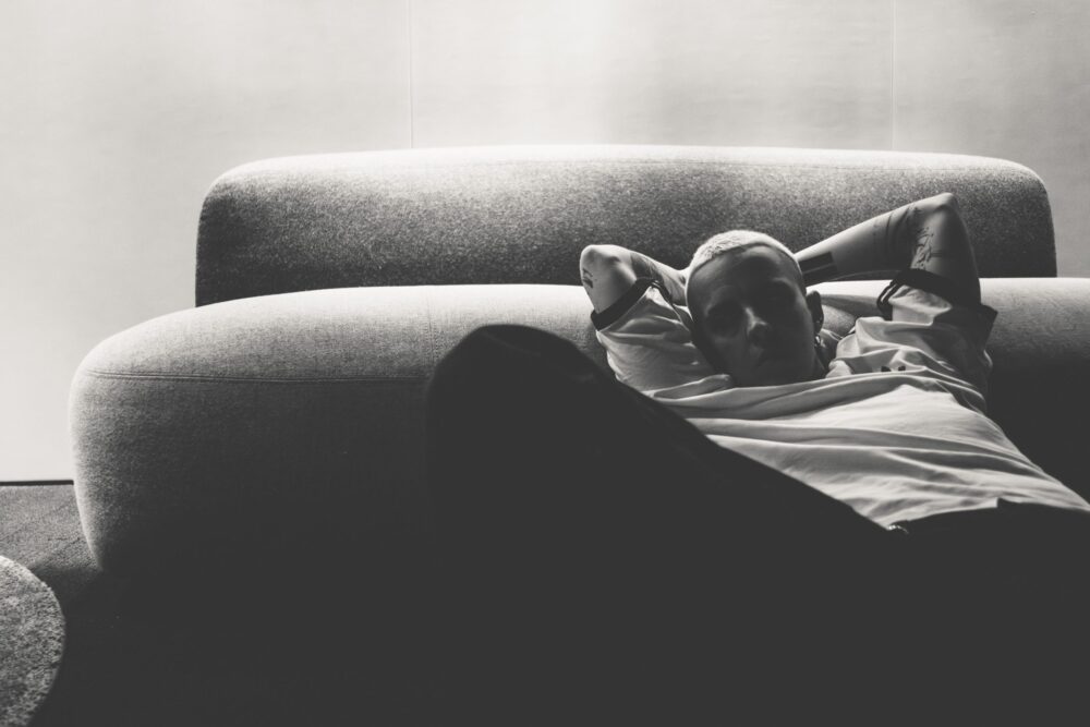 Mujer echada en un sofá. Fotografía en b/n