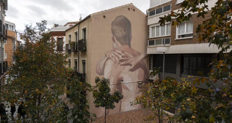 Mural de un hombre de espaldas con dos manos
