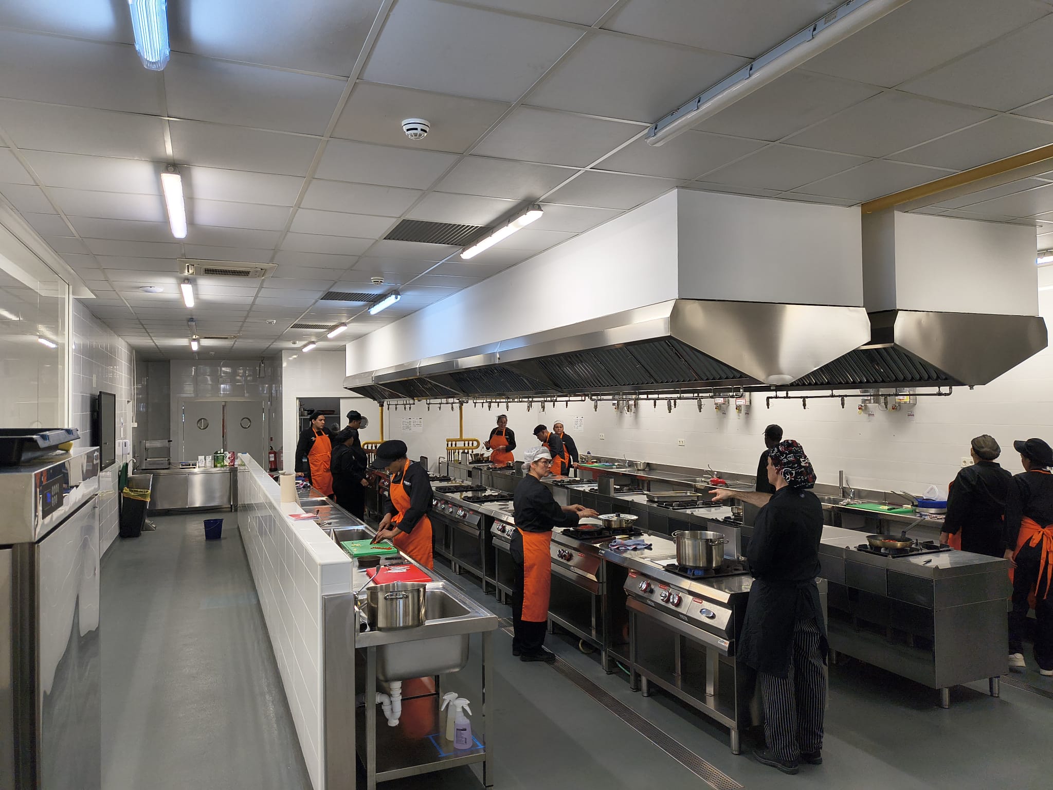 Alumnos de la Escuela Municipal de Hostelería y Alimentación de Madrid practicando el servicio de mesa con platos y fruta.