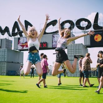 Imagen de archivo de la entrada al festival Mad Cool con dos chicas en primer plano saltando
