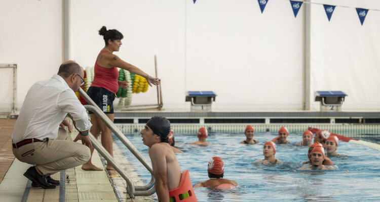 José Fernández charla al borde de la piscina con una de las participantes del curso de instructor de gimnasia acuática